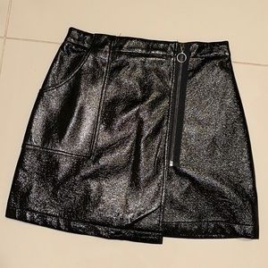 Black mini skirt with side pocket and zipper.